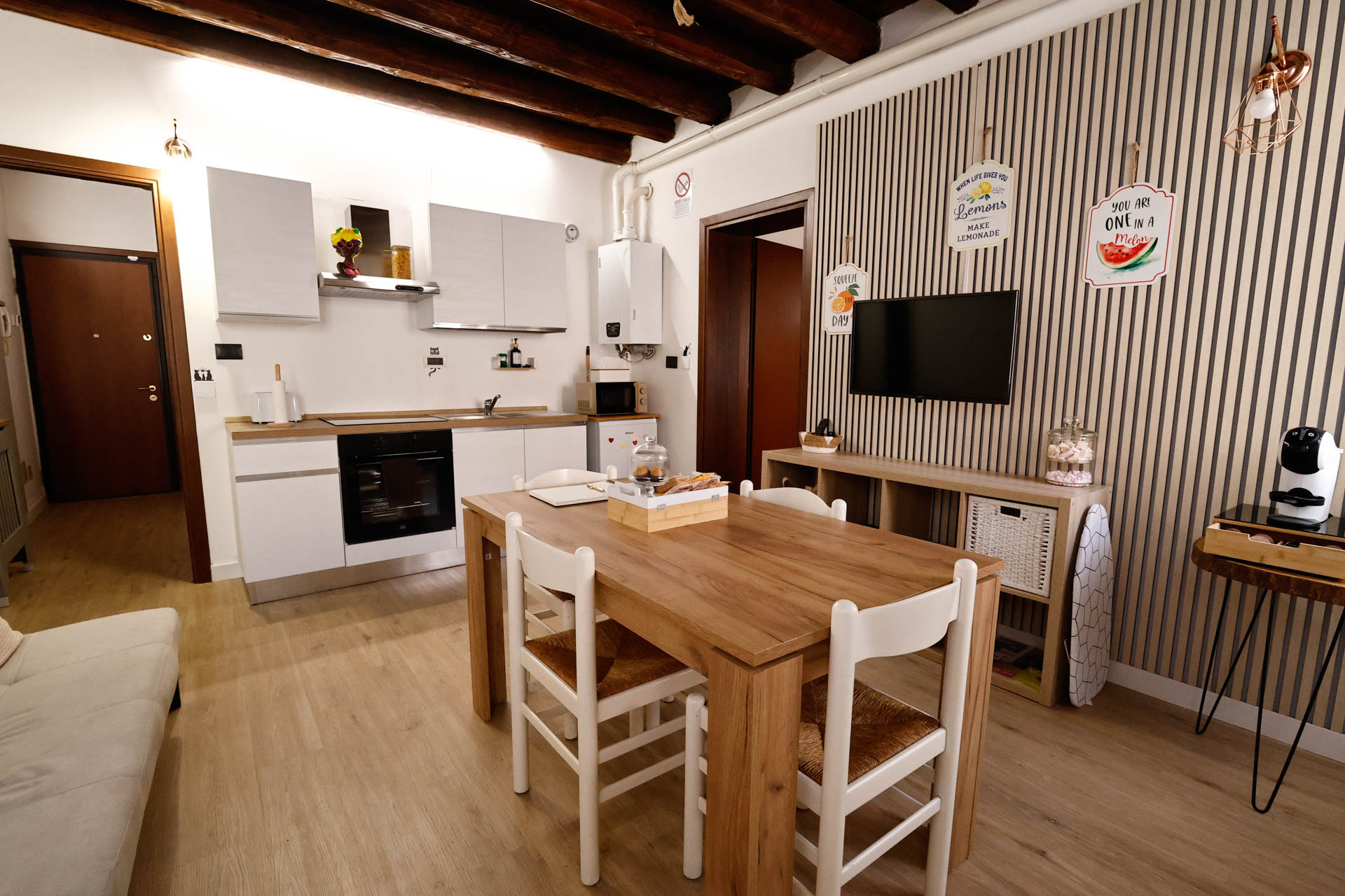_R4A8793 soggiorno e sala da pranzo e angolo cottura wood 32, con tavolo da pranzo, televisione a muro, caldaia, piano cottura con forno incassato, forno microonde, divano, macchina del caffè